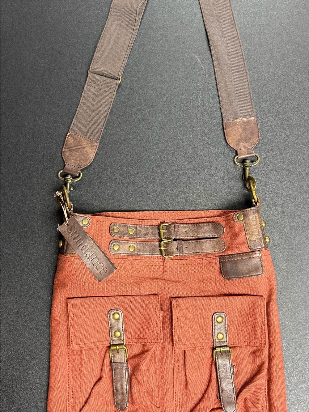 Sundance Rust Canvas Crossbody Bag with Brown Leather Trim and brass. Never used